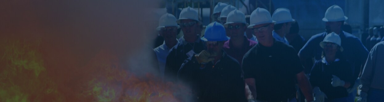 A group of firefighters dressed in gear walking, overlaid with a blue gradient